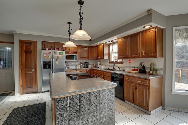 kitchen featuring sink, light tile patterned floors, a center island, black appliances, and decorative light fixtures