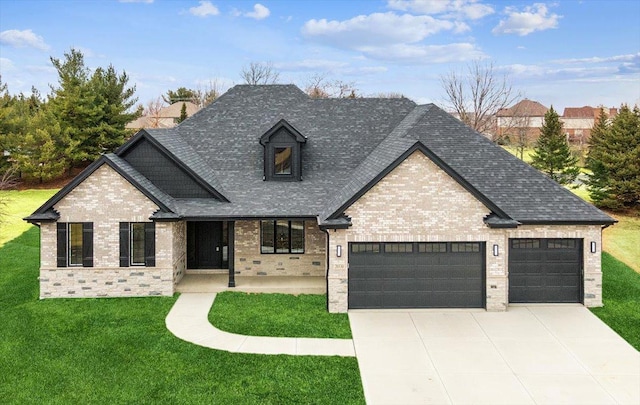 view of front of house with a garage and a front lawn