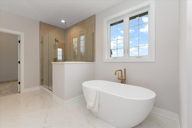 bathroom featuring shower with separate bathtub