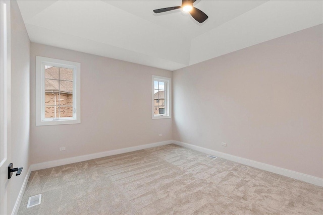 unfurnished room with ceiling fan, lofted ceiling, and light carpet