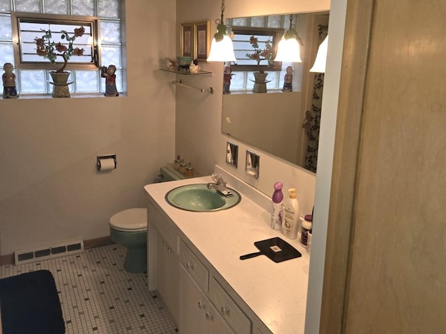 bathroom featuring tile patterned floors, plenty of natural light, vanity, and toilet