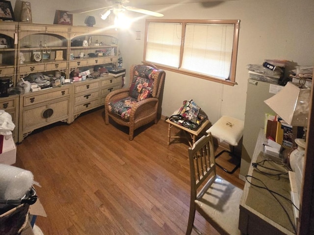 living area with hardwood / wood-style flooring and ceiling fan