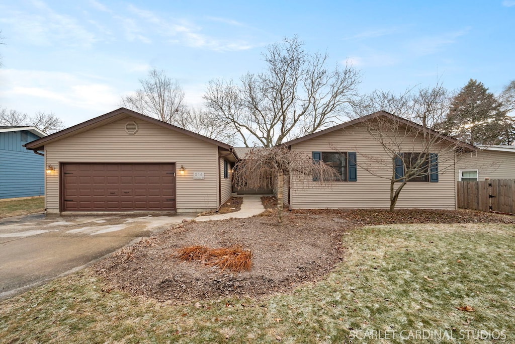 ranch-style home featuring a front yard and a garage