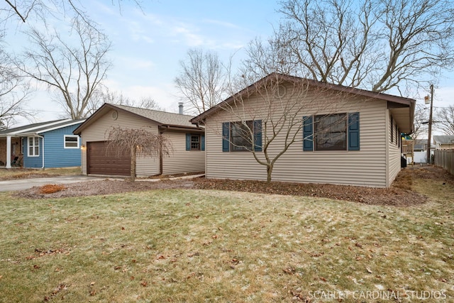 view of front of home with a front lawn and a garage