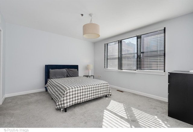 bedroom featuring light carpet