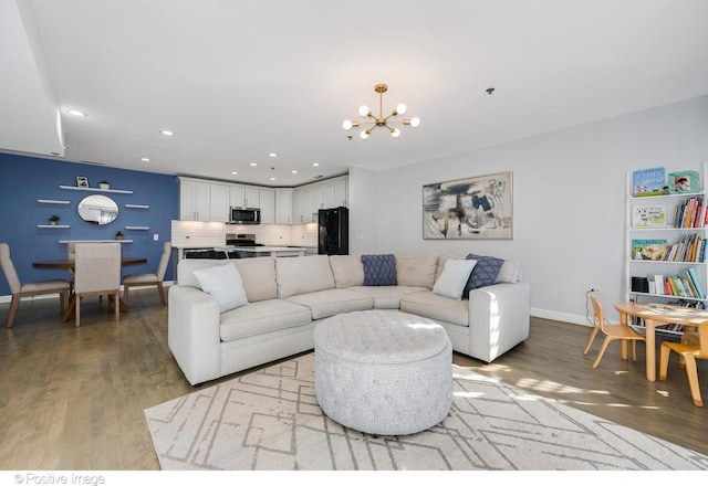 living room with a chandelier and light wood-type flooring