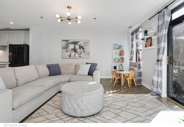 living room with a notable chandelier and hardwood / wood-style flooring