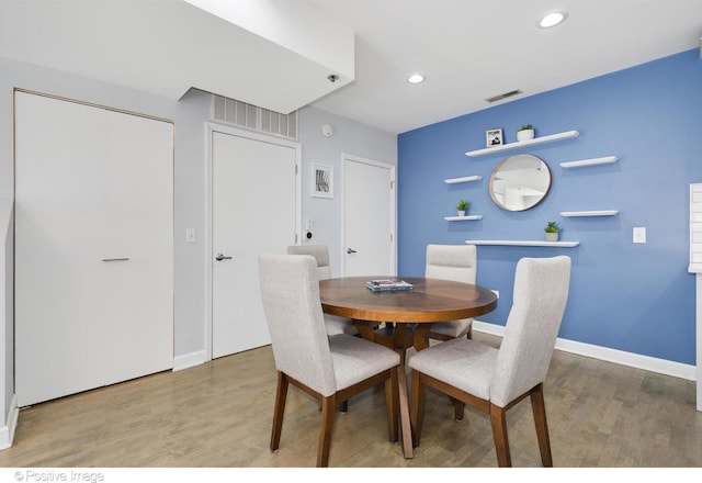 dining space with hardwood / wood-style flooring