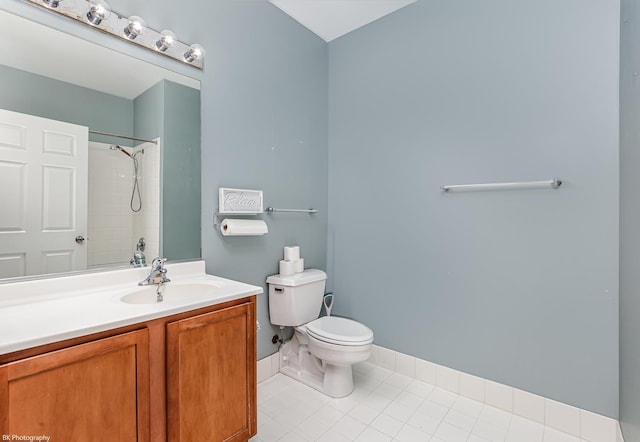 bathroom with tile patterned flooring, vanity, toilet, and walk in shower