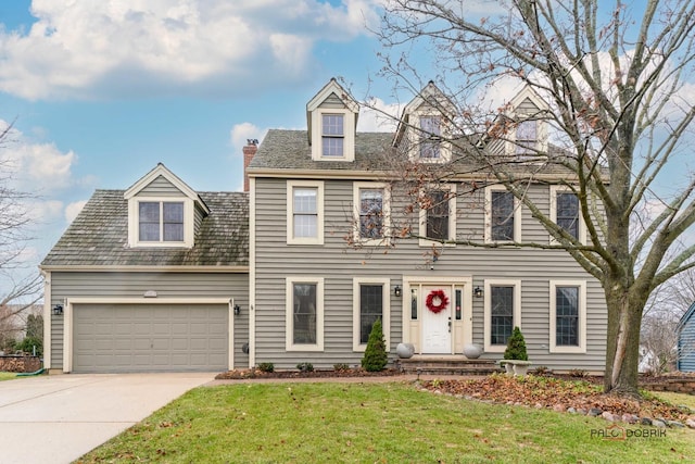 view of front of property featuring a front yard and a garage