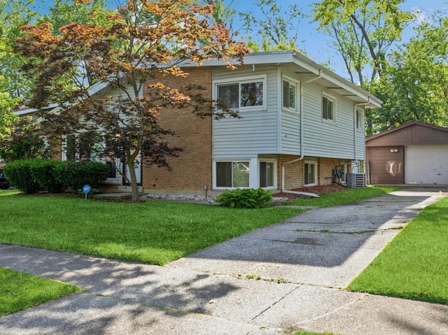 view of front facade with central AC, a garage, an outdoor structure, and a front lawn