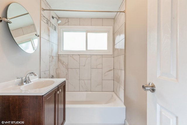 bathroom featuring vanity and tiled shower / bath