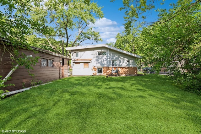 back of house with a lawn