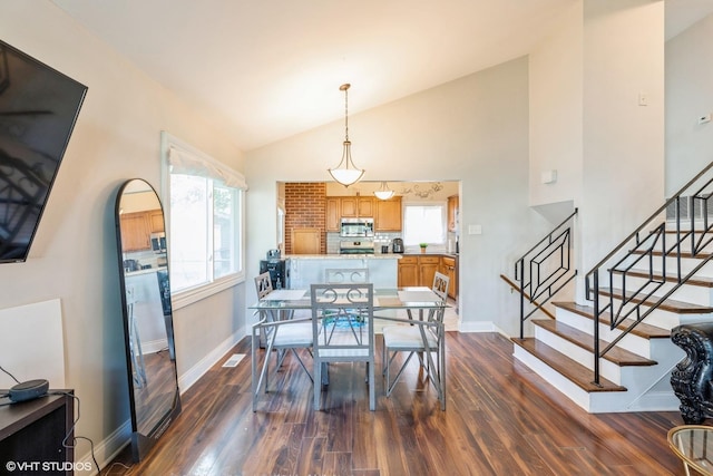 dining area with dark hardwood / wood-style flooring and lofted ceiling