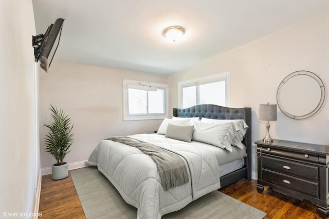 bedroom with dark hardwood / wood-style flooring