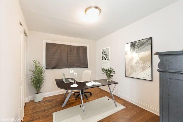 home office with dark hardwood / wood-style flooring