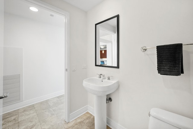 bathroom featuring toilet and sink