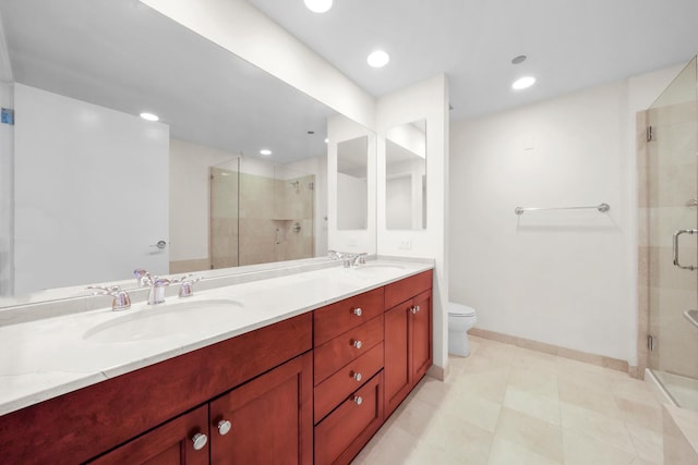 bathroom with vanity, toilet, and a shower with shower door