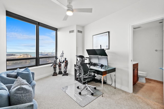 home office featuring light colored carpet and ceiling fan