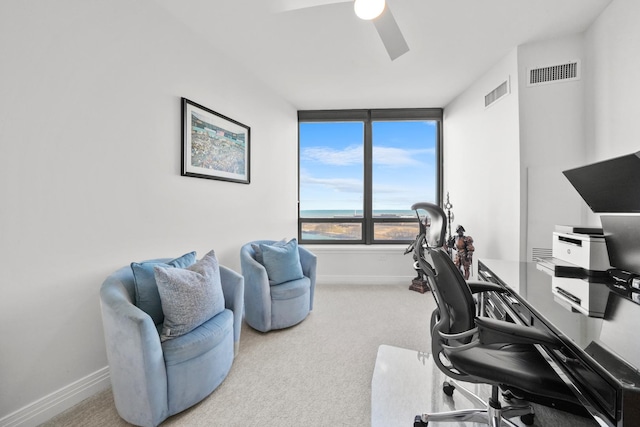 carpeted home office with ceiling fan