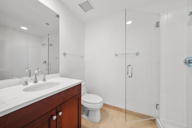 bathroom with tile patterned flooring, vanity, toilet, and an enclosed shower