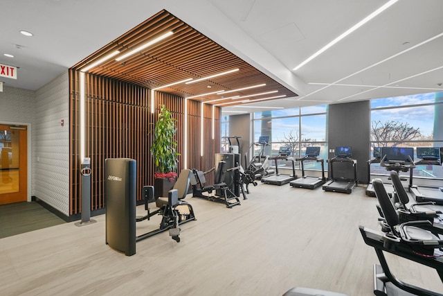 exercise room with hardwood / wood-style floors and expansive windows