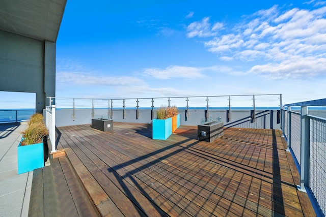 wooden terrace featuring a water view