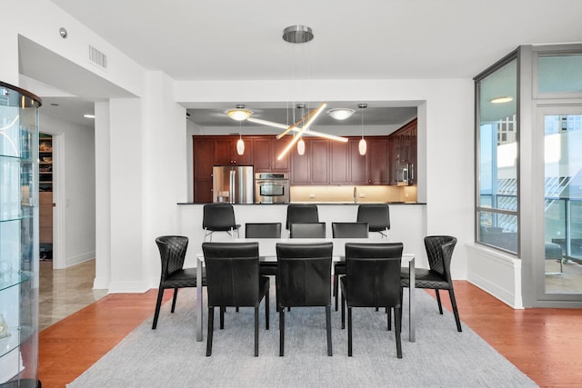 dining area featuring light wood-type flooring