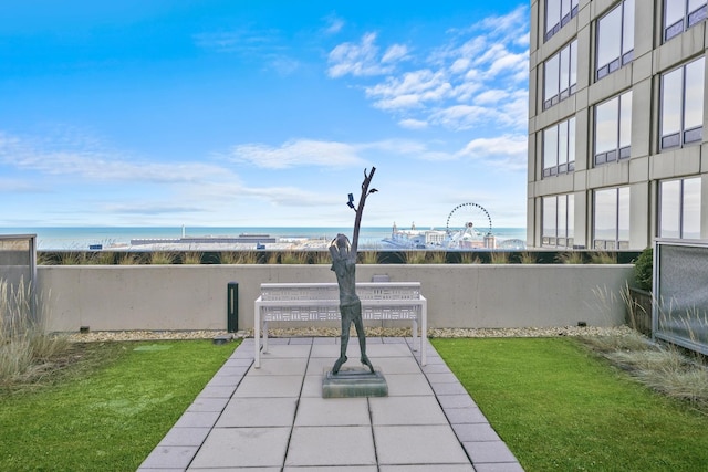 exterior space featuring a lawn and a water view