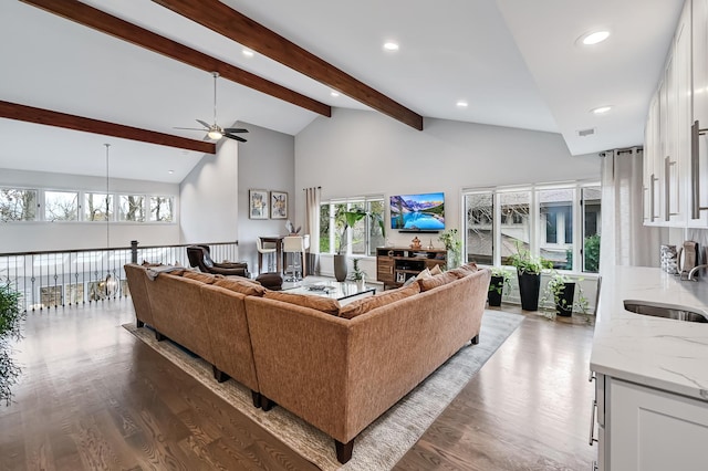 living room with beam ceiling, ceiling fan, sink, high vaulted ceiling, and hardwood / wood-style floors