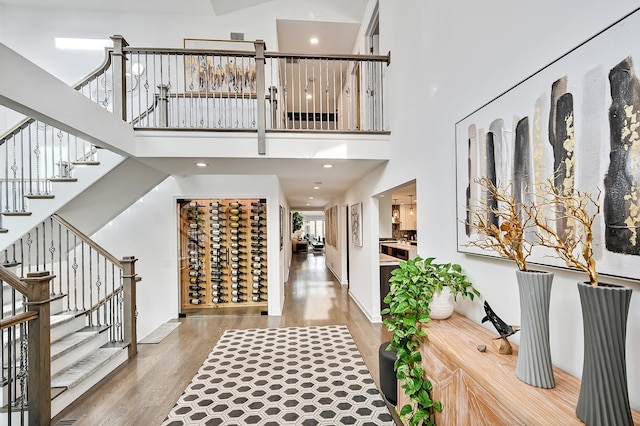 entrance foyer featuring hardwood / wood-style floors and a towering ceiling