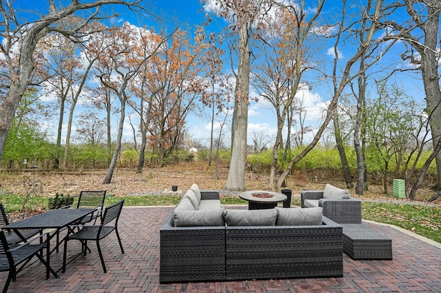 view of patio featuring an outdoor living space with a fire pit