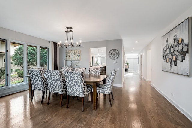 dining room featuring plenty of natural light, wood-type flooring, and an inviting chandelier