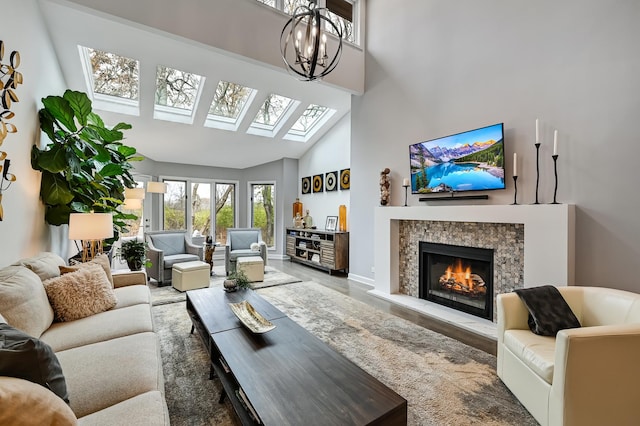 living room with high vaulted ceiling and an inviting chandelier