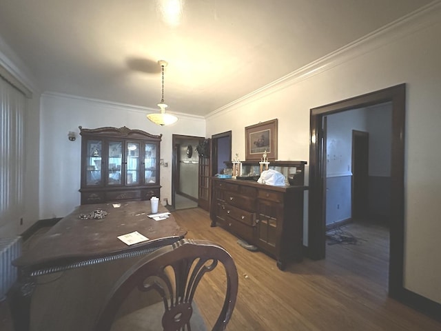 bedroom with hardwood / wood-style flooring and crown molding