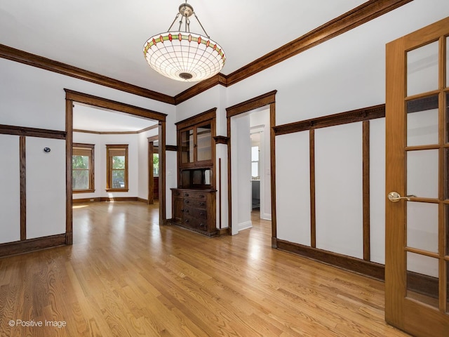 interior space featuring light hardwood / wood-style floors and ornamental molding