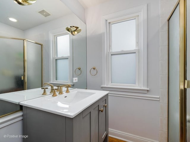 bathroom featuring vanity and an enclosed shower