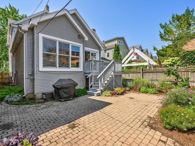 back of property with a patio and a deck