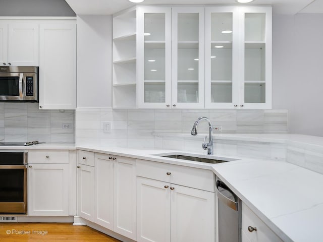 kitchen with sink, white cabinetry, and stainless steel appliances