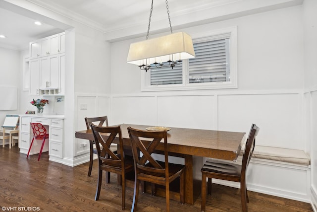 dining room featuring dark wood-type flooring and ornamental molding