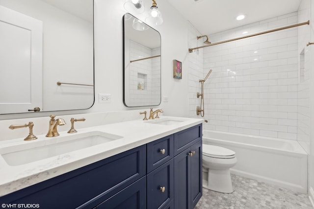 full bathroom featuring vanity, toilet, and tiled shower / bath