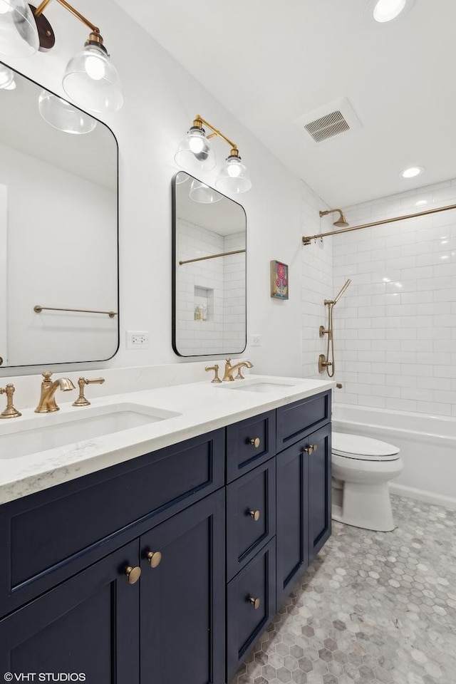 full bathroom featuring vanity, toilet, and tiled shower / bath