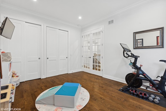 workout room with dark hardwood / wood-style flooring and ornamental molding