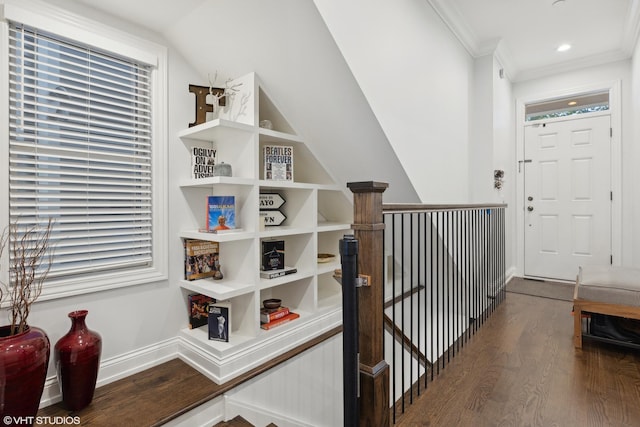 interior space with lofted ceiling, wood-type flooring, and crown molding