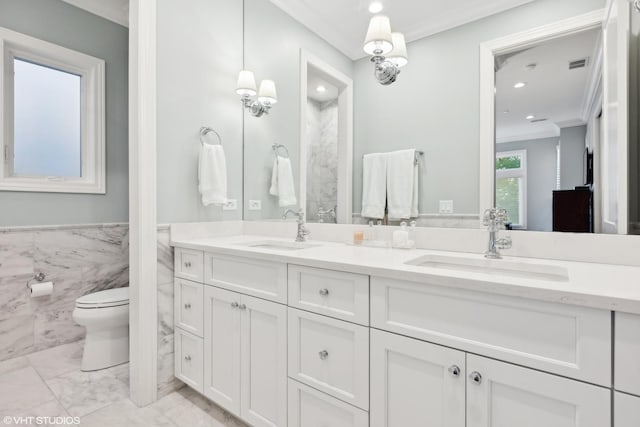 bathroom featuring vanity, toilet, tile walls, and ornamental molding