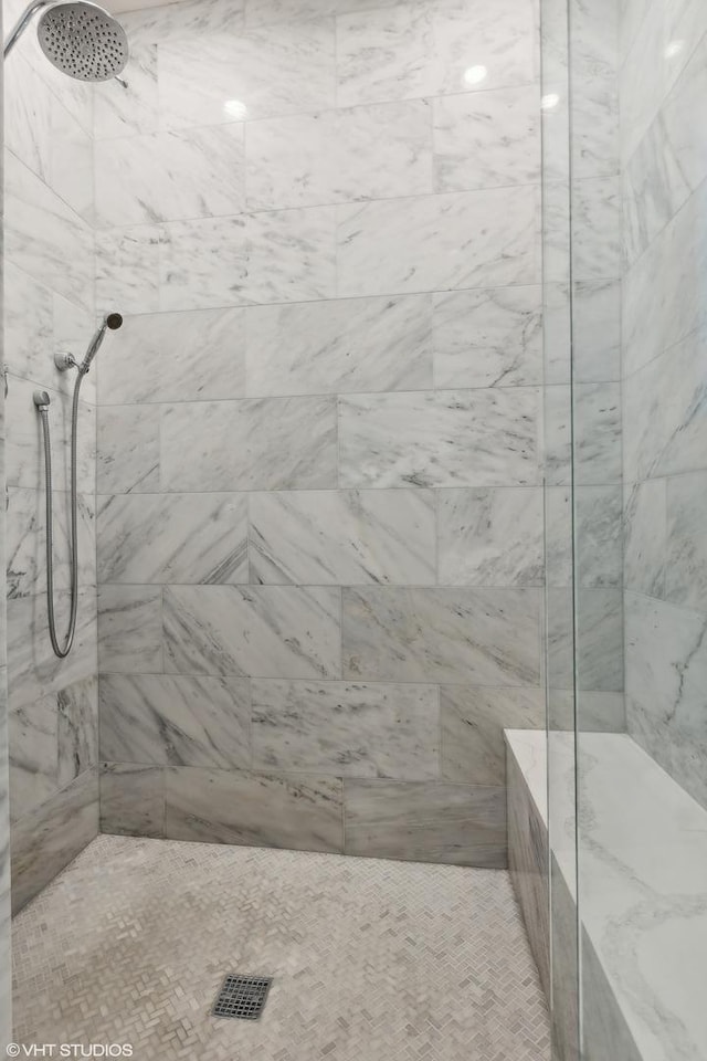 bathroom with a tile shower