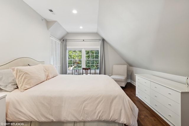 bedroom with dark hardwood / wood-style flooring and lofted ceiling