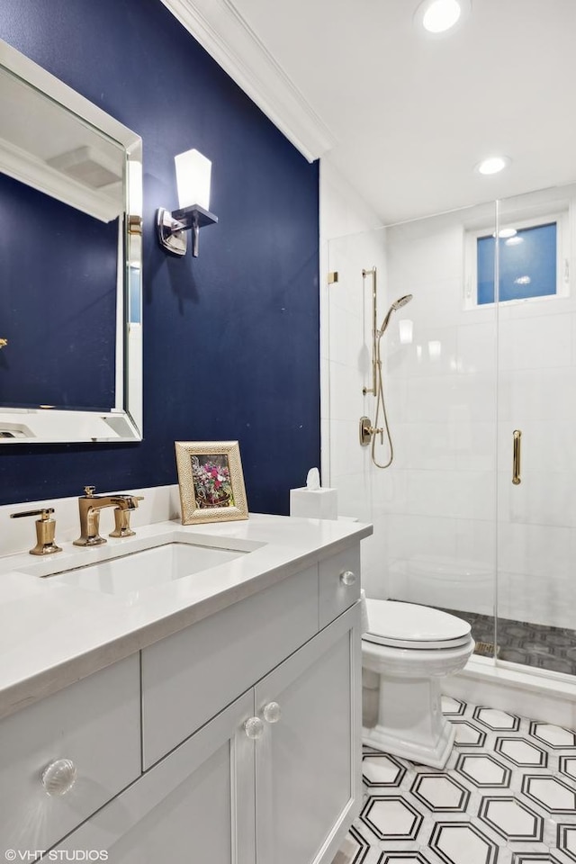 bathroom with crown molding, a shower with door, vanity, and toilet