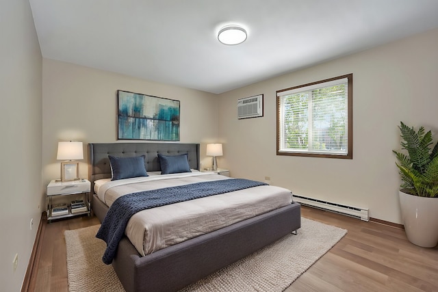 bedroom featuring a wall mounted air conditioner, wood-type flooring, and a baseboard heating unit