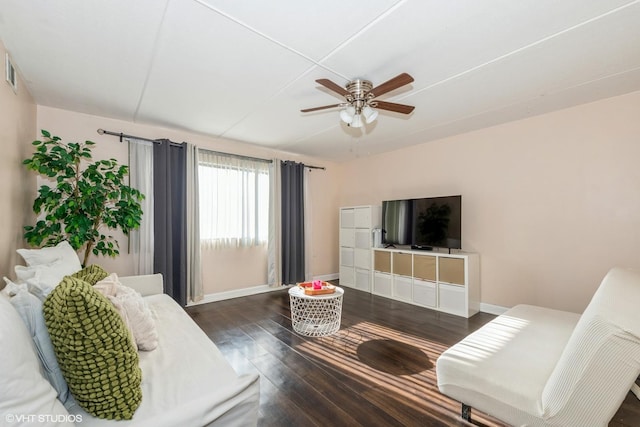 living room featuring ceiling fan and dark hardwood / wood-style floors